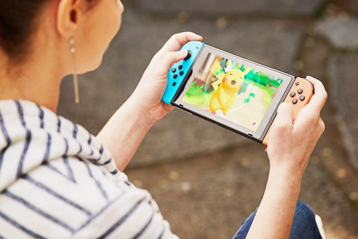 Woman playing with Nintendo Switch.